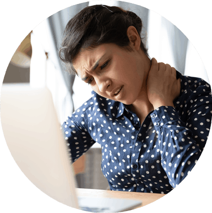 woman sitting at computer rubbing her neck